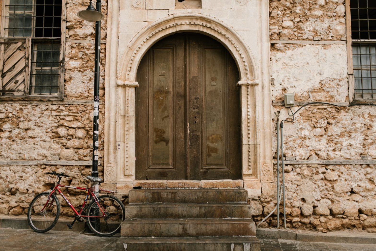 old stone building with arched wooden door